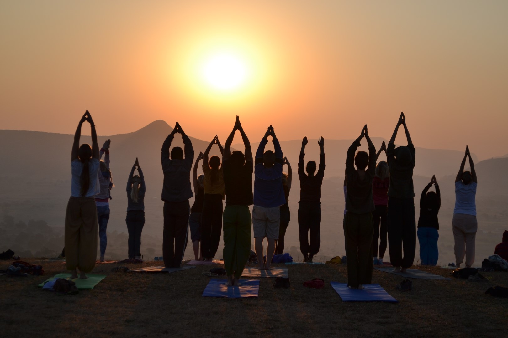 Group yoga at sunset